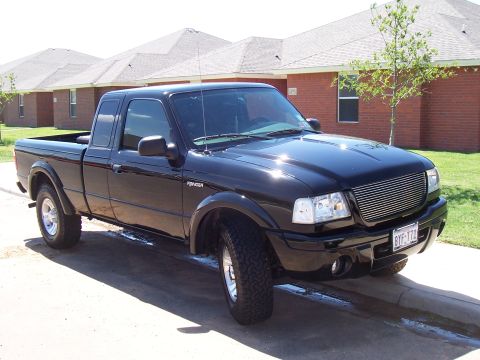 2003 Ford Ranger - Front 3/4 view of a black 2003 Ford Ranger pickup truck with a custom grille.