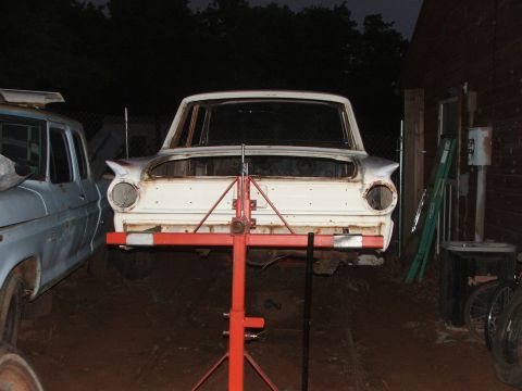 1963 Ford Fairlane - Front view of a white 1963 Ford Fairlane, appearing to be undergoing restoration or repair.