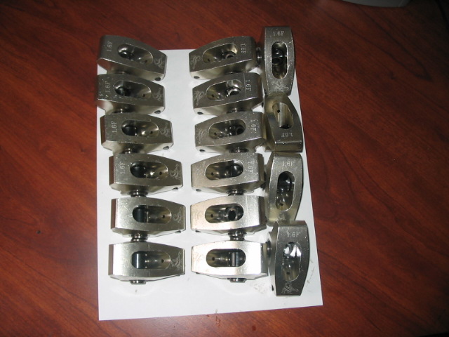 Set of 16 metal rocker arms with '1.6F' stamped on them