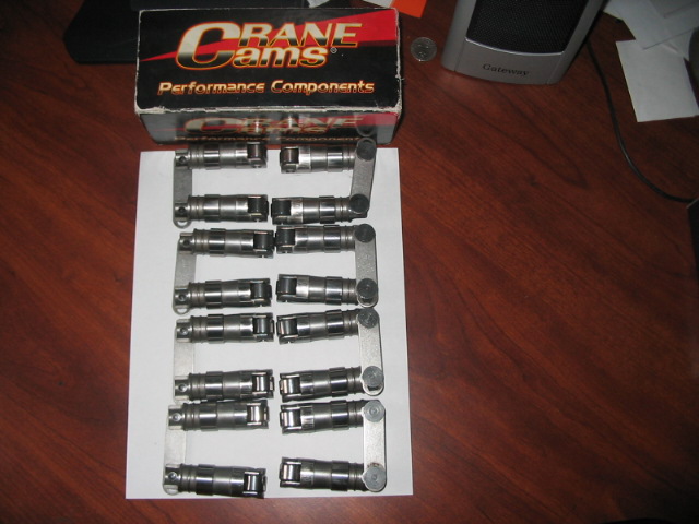 Crane Cams performance components box with engine lifters arranged on paper