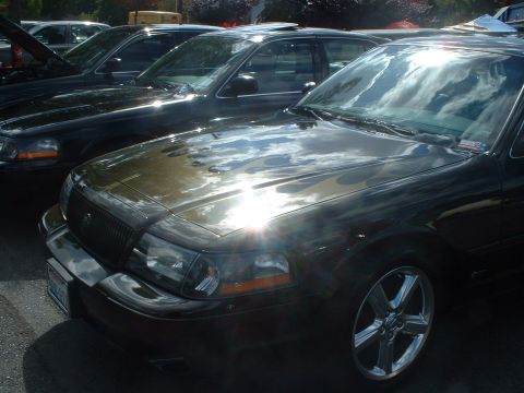 2000 Ford Crown Victoria - Front view of a 2000 Ford Crown Victoria, parked in a line with other vehicles.