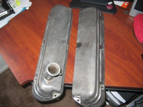 1991 Ford Bronco - A pair of aluminum valve covers are shown on a wooden desk surface.