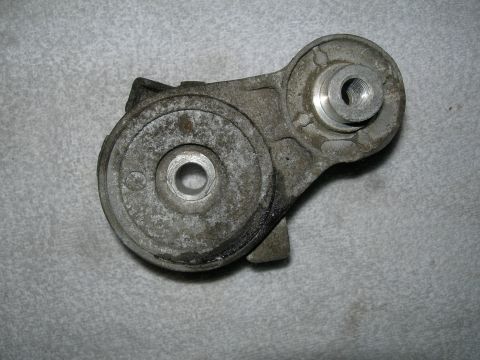 1992 Ford Taurus - Close-up view of a metal automotive part, likely a bracket or mount, with various threaded openings.