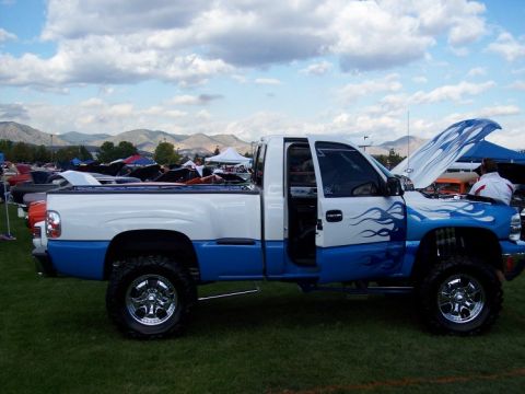 1972 Ford Ranchero - A customized pickup truck with a two-tone white and blue paint scheme flame graphics is displayed with its hood open.