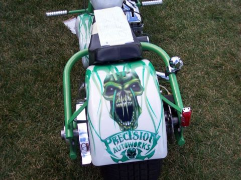 1972 Ford Ranchero - This custom motorcycle features striking green skull graphics and "PRECISION AUTOWORKS" lettering on its rear fender.