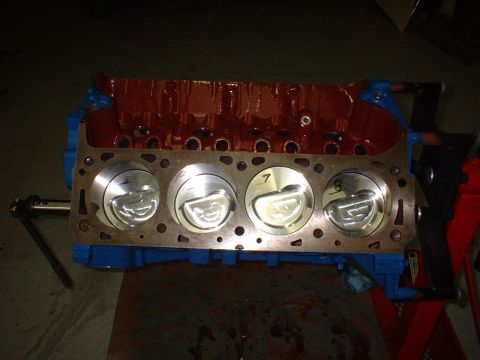 1969 Ford Mustang - An engine block with pistons is shown, with visible numbering on the pistons.