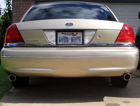2000 Ford Crown Victoria - Rear view of a gold 2000 Ford Crown Victoria, showing the dual exhaust pipes and Texas license plate.