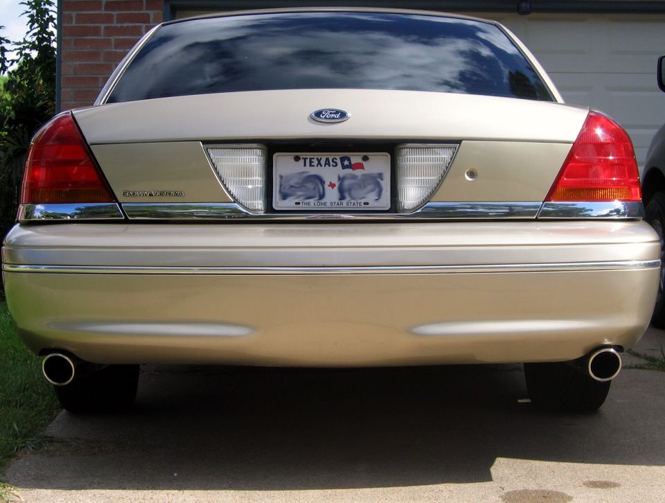 Gold 2000 Ford Crown Victoria rear view with dual exhaust pipes