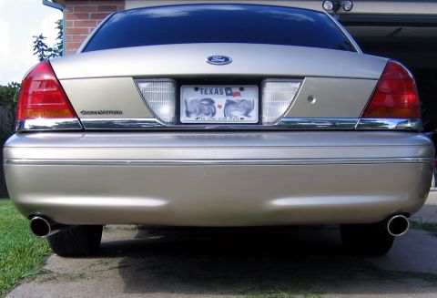 2000 Ford Crown Victoria - Gold 2000 Ford Crown Victoria rear end with dual exhaust pipes visible.