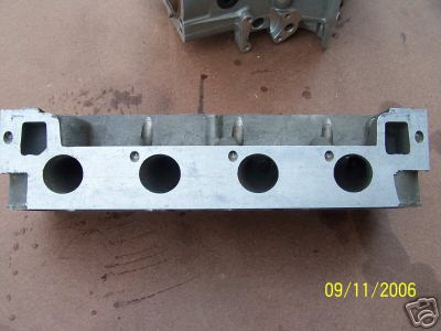 1972 Ford Ranchero - Close-up of an engine cylinder head, likely a spare part, with visible markings and legible text watermark.