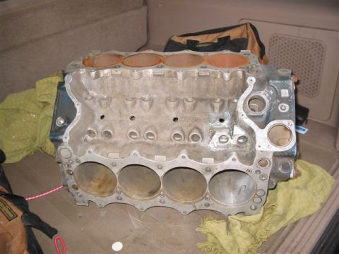 1972 Ford Ranchero - An engine block is shown inside a vehicle, with yellow and green cloths placed around it.