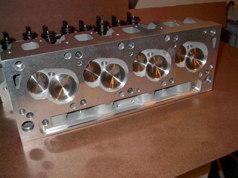 1972 Ford Ranchero - Close-up view of an aluminum engine cylinder head, its intricate design and polished valve seats.