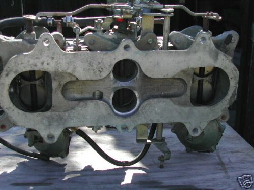 Dual carburetor intake manifold with linkages and fuel lines