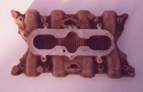 1972 Ford Ranchero - This is a cast iron intake manifold, likely for a V8 engine, shown against a plain background.