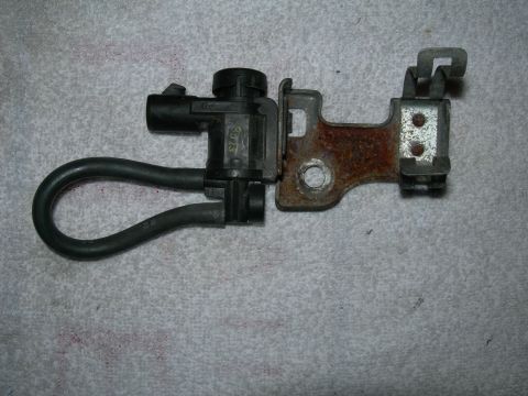 1992 Ford Taurus - This image shows a vacuum hose and valve assembly attached to a metal bracket, likely a replacement part.