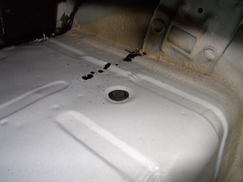1990 Lincoln Town Car - Naked trunk. There's a shot of one of the shock access plugs