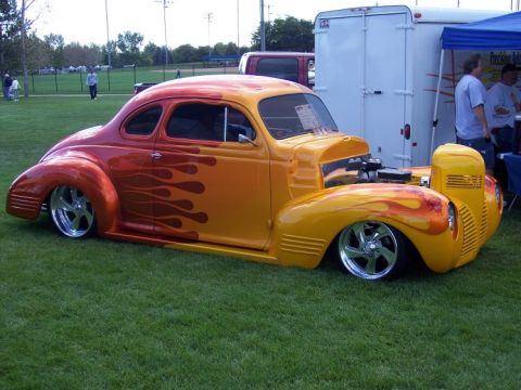 1972 Ford Ranchero - Custom hot rod with flame paint and exposed engine sits on a grassy field.