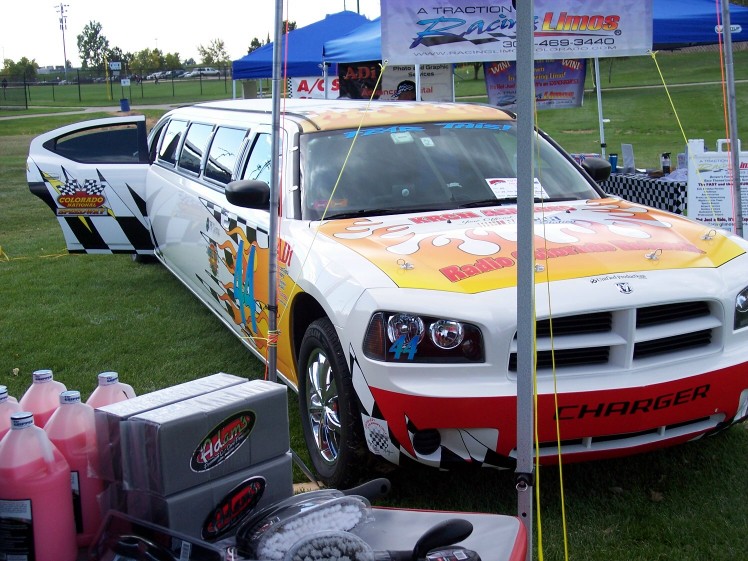White Dodge Charger limousine with racing graphics and "CHARGER" on the front bumper
