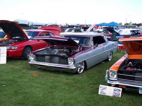 1972 Ford Ranchero - Several custom cars are on display at an outdoor event, with their hoods open.