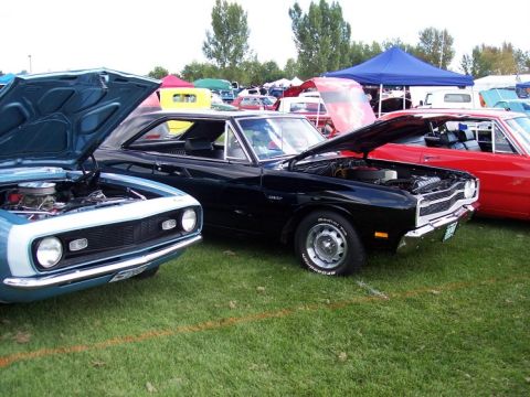 1972 Ford Ranchero - Three classic cars with hoods up at a car show event.