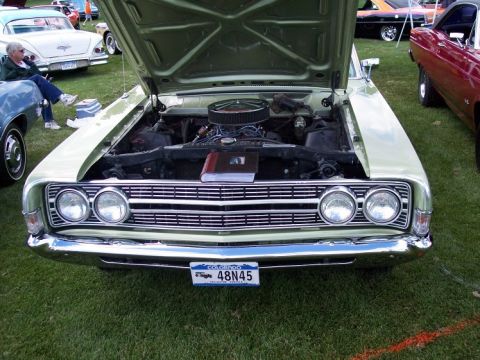 1972 Ford Ranchero - A light green 1970 Ford Ranchero is displayed with its hood open, revealing the engine and a book placed on top.