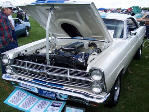 1972 Ford Ranchero - White 1967 Ford Ranchero GT with hood open, displaying its engine and blue racing stripes on the hood and grille.