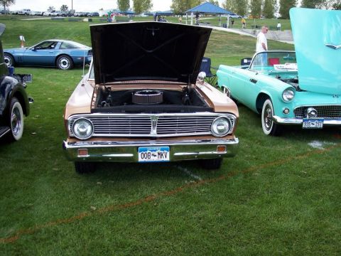 1972 Ford Ranchero - A 1964 Ford Falcon is displayed with its hood open at an outdoor car show.
