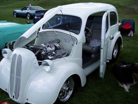 1972 Ford Ranchero - A custom hot rod is displayed with its hood and door open, showing off its engine and interior.