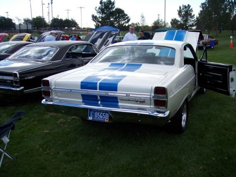 1972 Ford Ranchero - Rear view of a white 1970 Ford Torino GT with blue racing stripes at a car show.