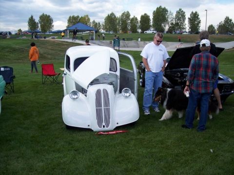 1972 Ford Ranchero - A white vintage car is displayed with its hood open at an outdoor car show.