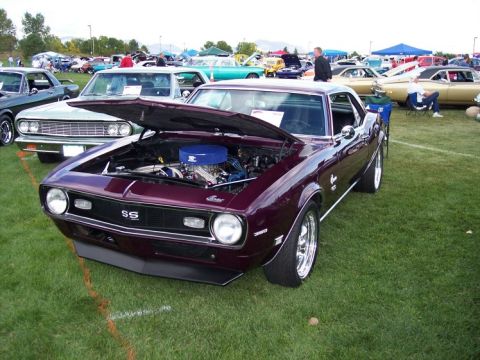 1972 Ford Ranchero - A 1969 Chevrolet Camaro SS is displayed with its hood open at an outdoor car show.