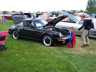 1972 Ford Ranchero - A black Porsche 911 is displayed with its hood open at an outdoor car show.