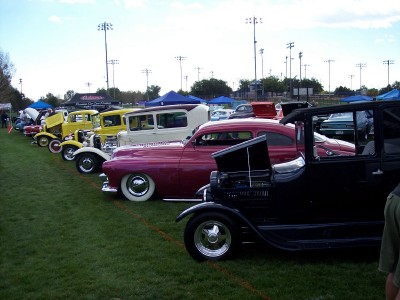 1972 Ford Ranchero - A row of vintage automobiles displayed outdoors at an event.