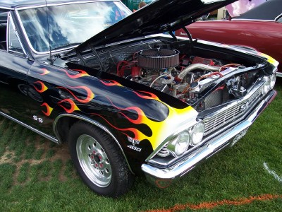1972 Ford Ranchero - A black 1967 Chevrolet Chevelle SS with flame decals is displayed with its hood open, revealing the engine.