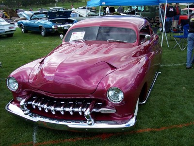 1972 Ford Ranchero - A heavily customized maroon coupe, likely from the early 1950s, is displayed at an outdoor car show.