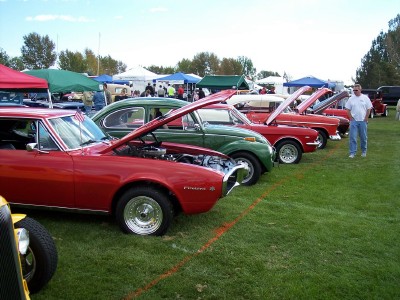 1972 Ford Ranchero - Multiple classic cars are displayed with their hoods open at an outdoor event.