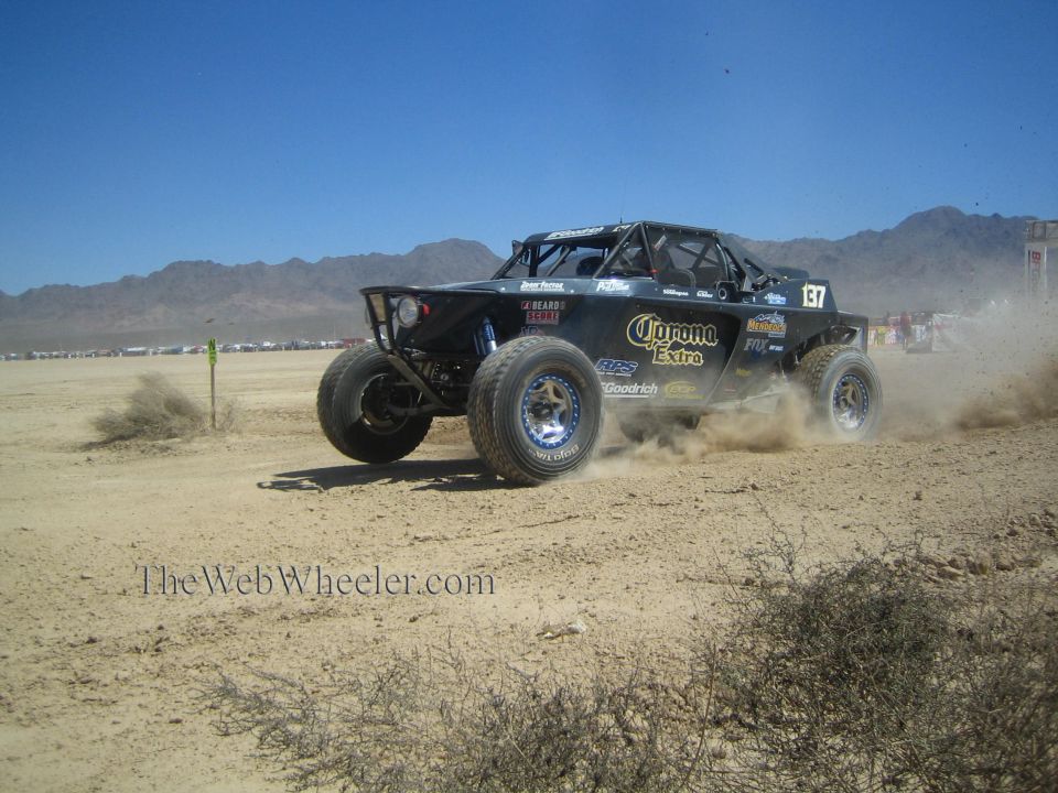 Black off-road race buggy number 137 with Corona Extra livery in the desert