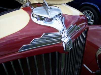 1972 Ford Ranchero - Hood ornament and grille detail on a classic two-tone automobile. Another vehicle is partially visible.