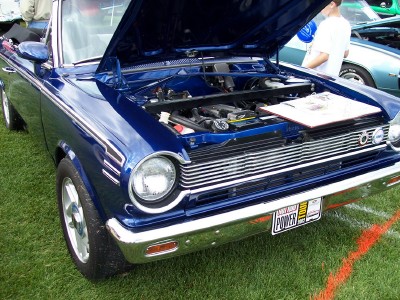 1972 Ford Ranchero - A blue 1966 AMC Rambler American is displayed with its hood open, revealing the engine compartment.