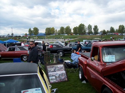 1972 Ford Ranchero - A variety of classic vehicles are on display at an outdoor car show under a cloudy sky.