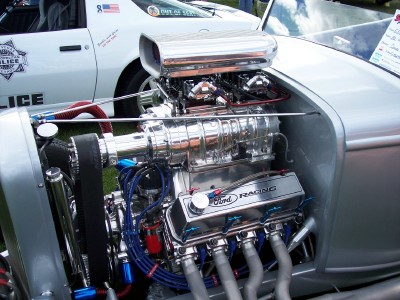 1972 Ford Ranchero - A highly customized engine dominates the foreground, with a police car visible in the background.