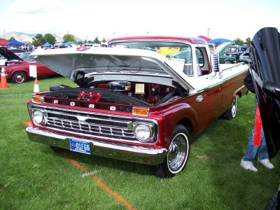 1972 Ford Ranchero - A classic Ford pickup truck is displayed with its hood open at an outdoor event.