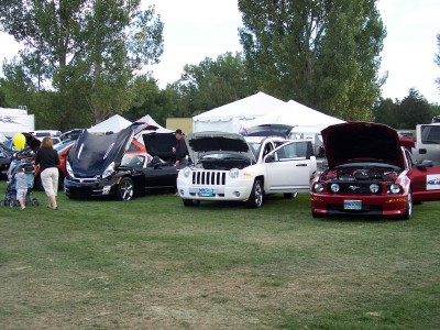 1972 Ford Ranchero - Several vehicles are displayed with their hoods open at an outdoor car show.