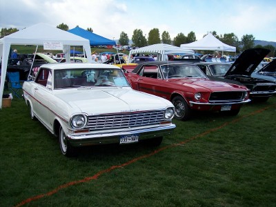 1972 Ford Ranchero - A white coupe with red trim and a prominent chrome grille is displayed at an outdoor car show.