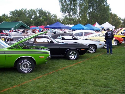 1972 Ford Ranchero - A car show displays multiple vintage vehicles on a sunny day, with tents set up for vendors and attendees.