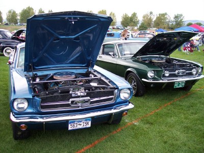 1972 Ford Ranchero - Two classic Ford Mustangs are displayed with their hoods open at an outdoor car show.