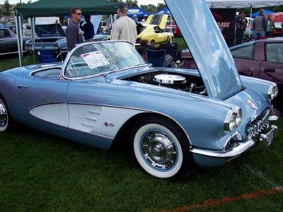 1972 Ford Ranchero - A light blue and white 1958 Chevrolet Corvette convertible is displayed with its hood open at an outdoor car show.