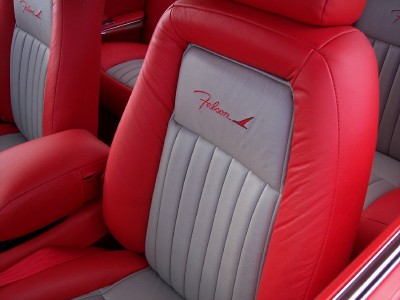 1972 Ford Ranchero - The interior of a car features red and gray seats with a 'Falcon' emblem.