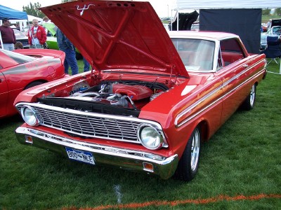 1972 Ford Ranchero - 1964 Ford Falcon at an outdoor car show, hood raised to display the engine bay.