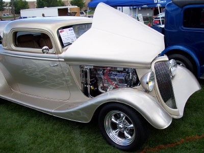 1972 Ford Ranchero - A gold custom coupe hot rod is displayed with its hood open, revealing the engine compartment.